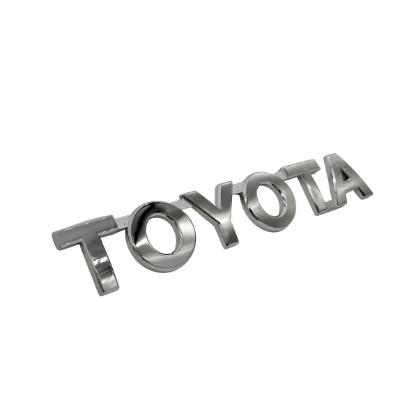 1_637557545285451058 EMBLEMA "TOYOTA" DE PORTON HILUX-SW4 2005-2015 Original - Imagen 1