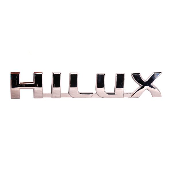 754270K01101 EMBLEMA PALABRA "HILUX" HILUX 2005-2015 Taiwan - Imagen 1